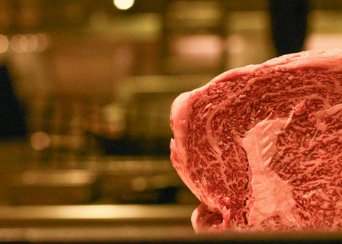 A large slab of wagyu beef, revealing delicate marbling.